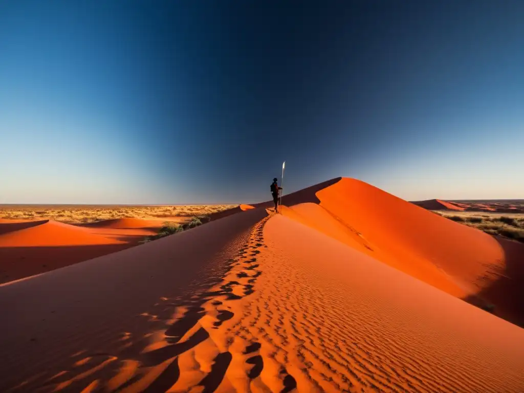 Resiliencia ancestral en el Desierto Victoria Un aborigen camina por el desierto de Victoria, mostrando su cultura y supervivencia en este vasto paisaje